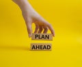 Plan ahead symbol on Wooden blocks. Beautiful yellow background. Businessman hand. Business and 'Plan ahe Royalty Free Stock Photo