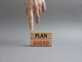 Plan ahead symbol. Wooden blocks with words Plan ahead. Beautiful grey background. Businessman hand. Business and Plan ahead Royalty Free Stock Photo