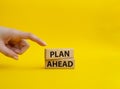 Plan ahead symbol. Wooden blocks with words Plan ahead. Beautiful yellow background. Businessman hand. Business and Plan ahed Royalty Free Stock Photo