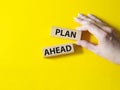 Plan ahead symbol. Wooden blocks with words Plan ahead. Beautiful yellow background. Businessman hand. Business and Plan ahe Royalty Free Stock Photo