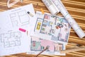 Plan of apartment rooms and blueprint rolls with work tolls Royalty Free Stock Photo