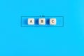 Plan a, b and c on wooden cubes on blue background. Choosing a business strategy plan