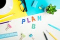 PLAN B word on desk office background with supplies. Royalty Free Stock Photo