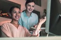 Cheerful dark-skinned female sitting at her workplace