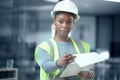 The plan is everything. Cropped portrait of an attractive young female architect looking at blueprints while standing in Royalty Free Stock Photo