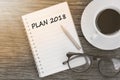 Plan 2018 on notebook with coffee cup, glasses and pencil on woo Royalty Free Stock Photo
