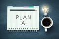 Plan a on notepad on a blue background. Royalty Free Stock Photo