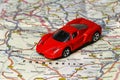 Planning a car trip to France. Toy car is on a country map.