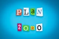 Plan-2020. Text on a blue background, multicolor paper letters. Inscription. The planning concept. Single word on banner