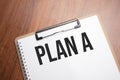 plan a text on white paper on the wood table Royalty Free Stock Photo