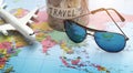 Plan to travel with sunglasses on world map