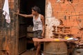 Planaltina, Goias, Brazil-April 21, 2018: A young woman stands outside her home in the impoverished community of Planaltina, Brazi