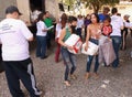 Poor people mostly women receiving food and other goods called Cesta Basic