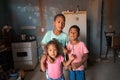 Three siblings inside the kitchen of their poor house