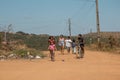 Planaltina, GoiÃÂ¡s, Brazil-July 6, 2019: A family walking down a dirt street