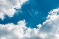 A plane above the clouds in the deep blue sky