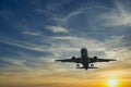 The plane against the blue sunset sky. The setting sun Royalty Free Stock Photo