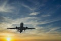 The plane against the blue sunset sky. The setting sun. Sunset Royalty Free Stock Photo