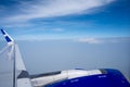 A plane in the air, taken from inside the airplane. Cloud view from plane. Creative plane shot