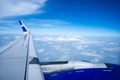 A plane in the air, taken from inside the airplane. Cloud view from plane. Creative plane shot