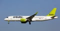Plane Airbaltic airline lands on the runway in an aeroport El Prat city of Barcelona