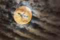 plane, aircraft silhouette against full moon Royalty Free Stock Photo