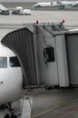 Plane on airport connected to gate sleeve. Aircraft and sleeve. Gate at the airport for passengers to plane boarding.