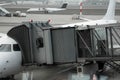 Plane on airport connected to gate sleeve. Aircraft and sleeve. Gate at the airport for passengers to plane boarding.