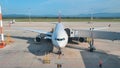 The plane at the airport is waiting for departure at the terminal. Royalty Free Stock Photo