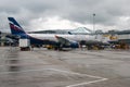 The plane arrived at its destination and stands on the airfield near the airport buildings. Editorial Photo Royalty Free Stock Photo