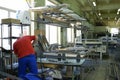 Worker assembling fuselage of a light passenger plane at the assembly hall