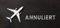 Plane on a black background with german text annuliert, in english cancelled Royalty Free Stock Photo