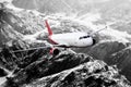 Plane red black white travel transportion airplane mountains Royalty Free Stock Photo