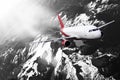 Plane red black white cloud travel transportion airplane mountains Royalty Free Stock Photo