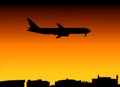 Plane and city skyline at sunset Royalty Free Stock Photo