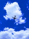 Plane in deep blue sky with clouds Royalty Free Stock Photo