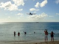 A plane is descending towards Princess Juliana International Airport SXM over the beach