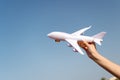 Plane in female hand clear blue sky background copy space. Travel and vacation. Book tickets now. Toy white plane fly Royalty Free Stock Photo