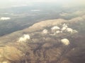 The plane flies at a great height with a view of the mountains, stones, clouds and fog. land view from above. passengers fly in an