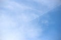 Plane flies high in the sky among clouds Royalty Free Stock Photo