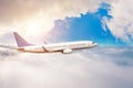 The plane flies in layers of dense white clouds and bright sun Royalty Free Stock Photo