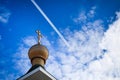 The plane flies in the sky above the Orthodox Church