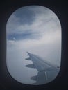 Plane Flight Through The Dense Foggy Clouds. Airplane Wing Seen Through The Window