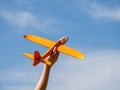 A plane flying away into the distance against the background of a blue sky, the theme of travel and flights, open borders for trav