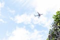 Plane flying at low altitude in a cloud sky and cleared