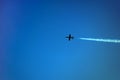 A plane flying over the blue sky background. Air show at Chisinau National Airport in Moldova. Airplane with dense decorative Royalty Free Stock Photo