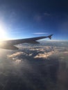 Lensflare behind airplane wing early morning as it flies over SLC Utah Royalty Free Stock Photo