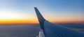 Plane flying over Greek islands at sunset, Aegean sea view out of airplane window