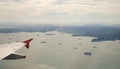 The plane flying over the sea in Singapore Royalty Free Stock Photo