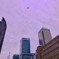 Airliner flying over Canary Wharf in London Royalty Free Stock Photo